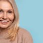 Woman smiling against blue background