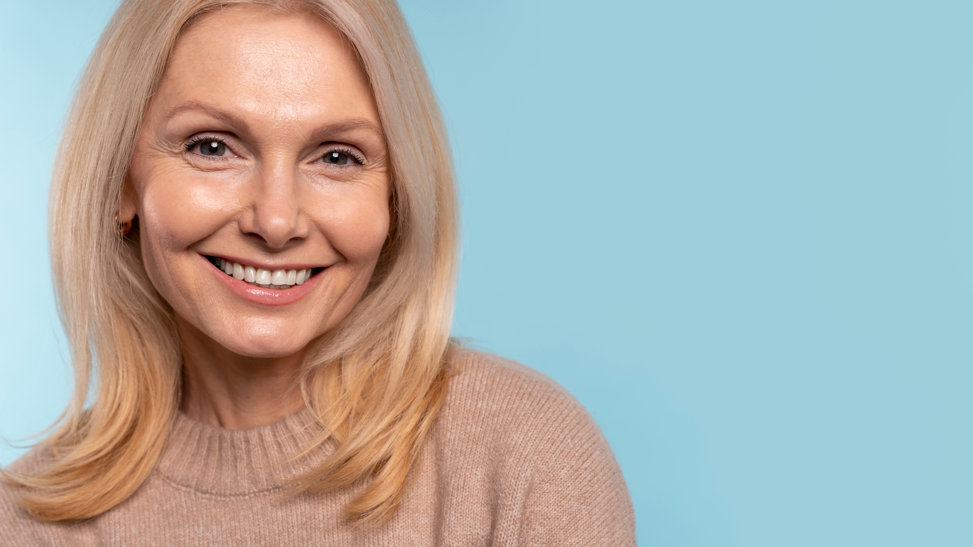 Woman smiling against blue background